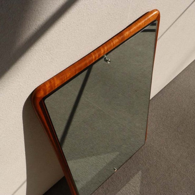 Mid-century British vintage wall mirror with rounded corners, teak frame showcasing warm wood grain and smooth finish.