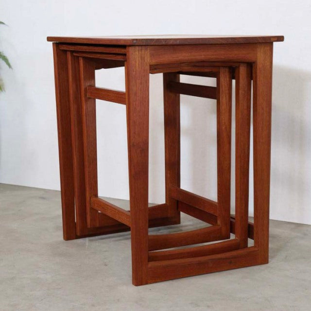 Set of vintage British mid-century teak nesting tables with smooth wood grain and clean rectangular frames from Denmark.