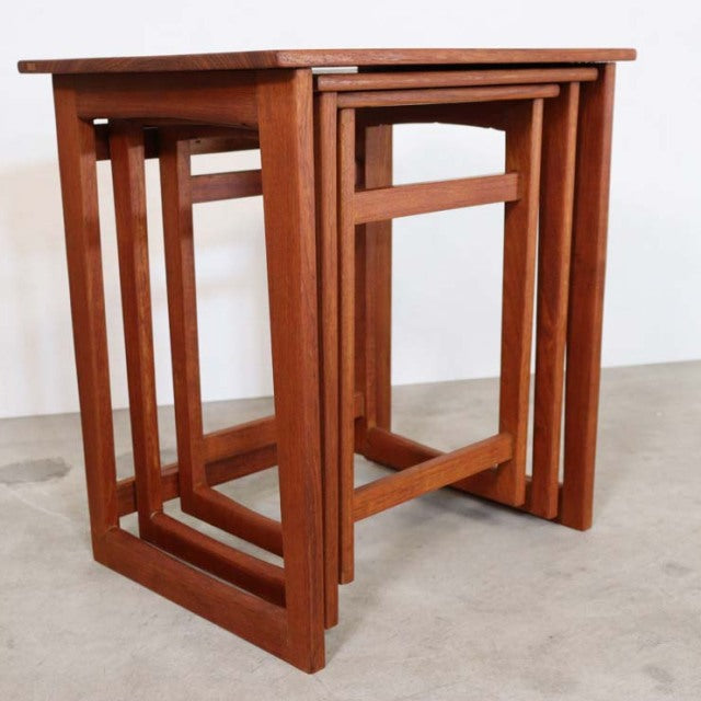 Mid-century British vintage teak nest tables with clean lines and visible wood grain, featuring square legs and a nested.