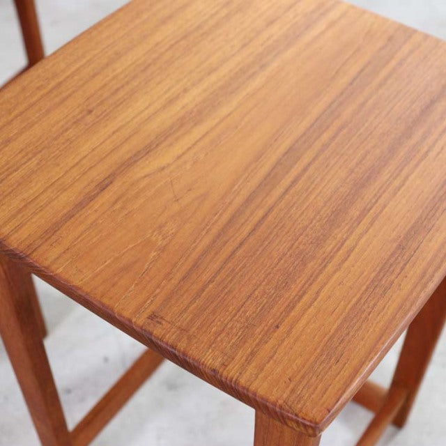 Mid-century British vintage teak nest table with smooth wood grain and clean square edges.