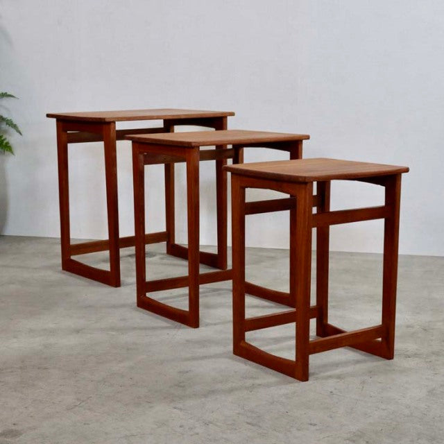 Set of three vintage teak nest tables with clean mid-century British design, showcasing rich wood grain and straight square.