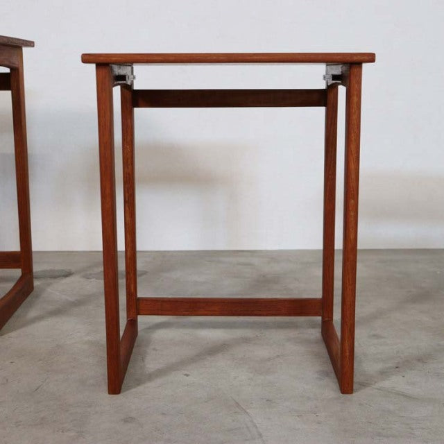 Mid-century British vintage teak nest table with clean lines, visible wood grain, and slender rectangular legs.