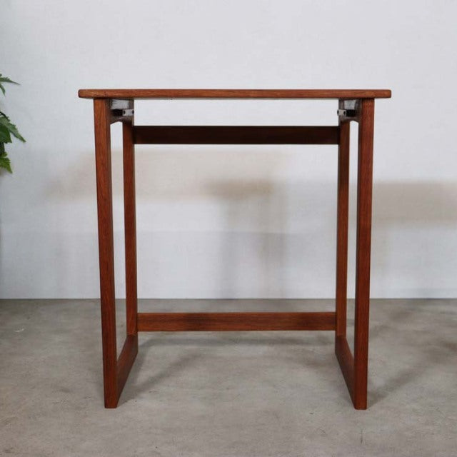 Mid-century British vintage teak nest table with clean lines, visible wood grain, and slender square legs.