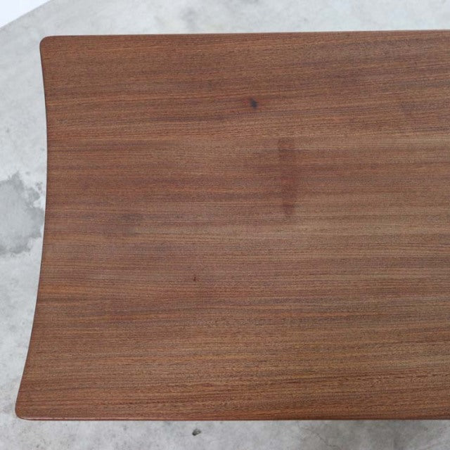 Vintage teak mid-century British coffee table by Richard Hornby with smooth wood grain top and curved edges.