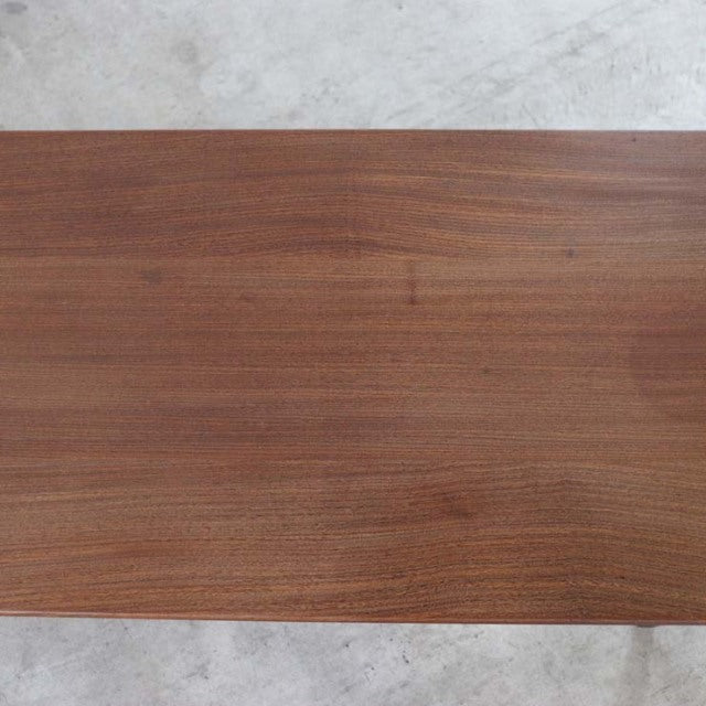 Vintage British mid-century teak coffee table by Richard Hornby with smooth wood grain top and integrated magazine rack.