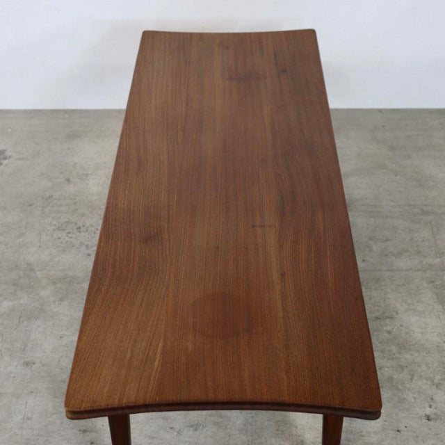 Vintage British mid-century teak coffee table by Richard Hornby with smooth wood grain and tapered legs.