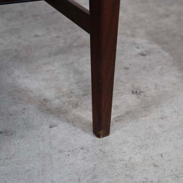 Close-up of a tapered teak leg on a vintage British mid-century Richard Hornby coffee table with magazine rack, showing rich .
