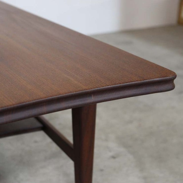 Mid-century British teak coffee table corner with smooth wood grain and tapered leg detail from Richard Hornby.