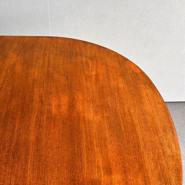 Vintage teak oval dining table top with rich wood grain from British mid-century Denmark design.