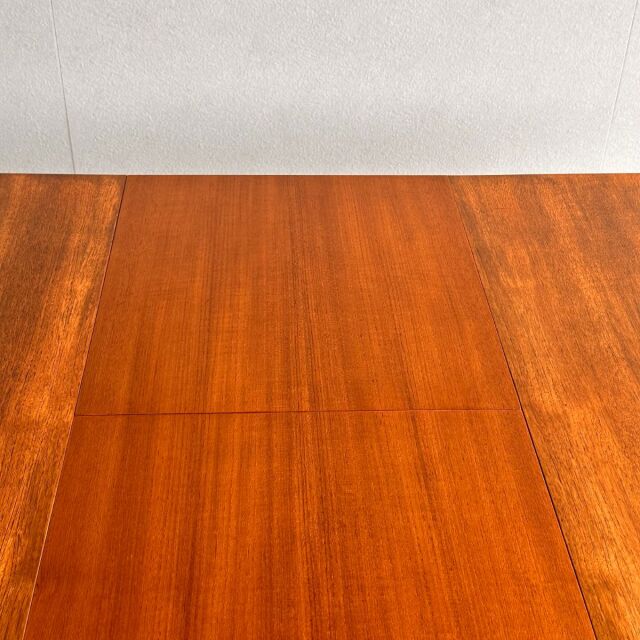 Mid-century British vintage teak oval dining table with rich wood grain and smooth finish.