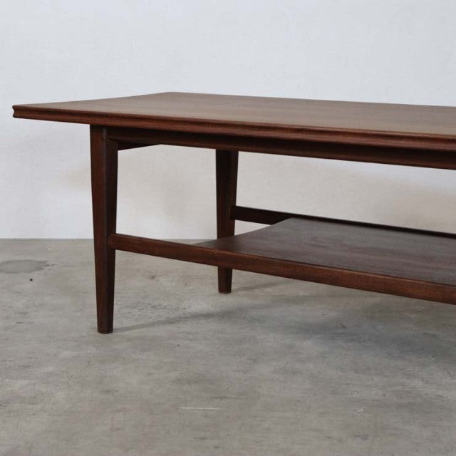 Vintage British mid-century teak coffee table by Richard Hornby with magazine rack and tapered legs.