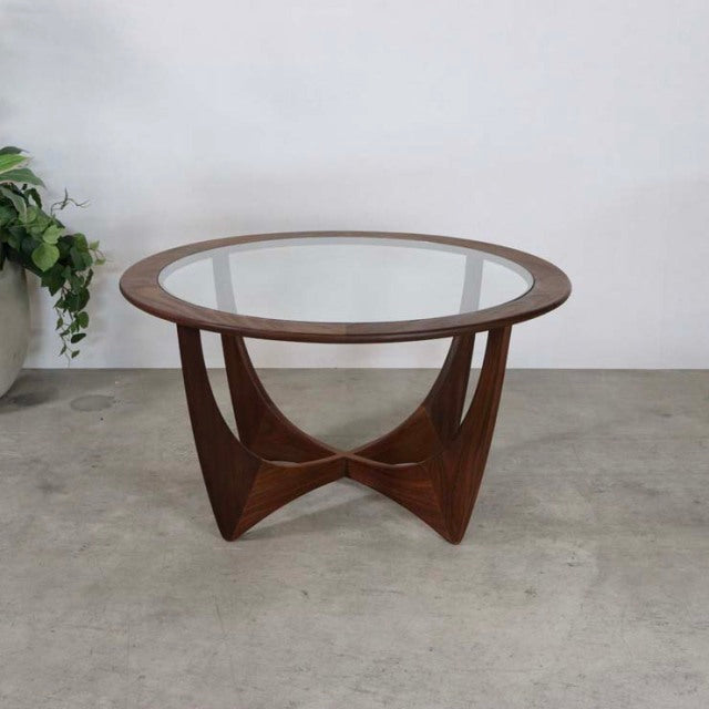 Vintage mid-century British G-PLAN teak coffee table with round glass top and sculpted curved legs.