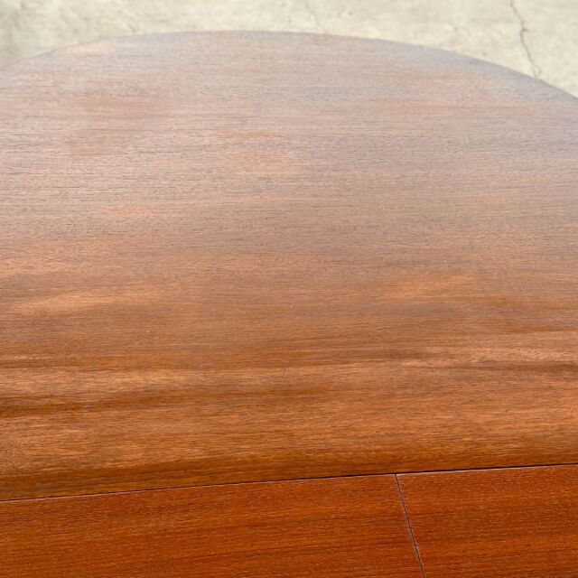 Vintage mid-century teak oval dining table with smooth wood grain and warm British finish.