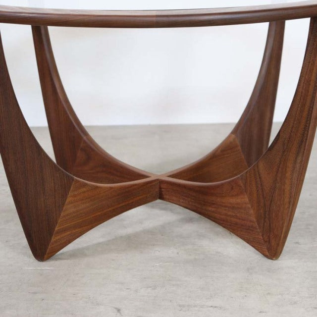 Mid-century British G-PLAN teak coffee table base with sculpted triangular legs and rich wood grain.