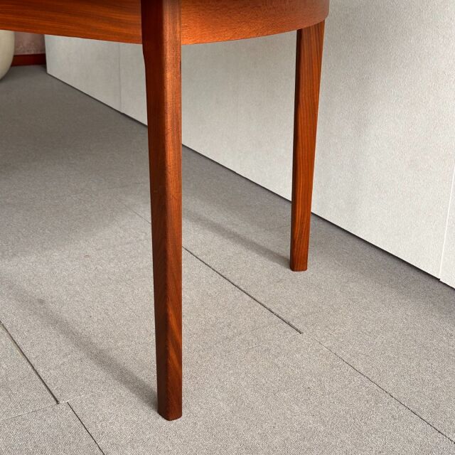 Mid-century British vintage teak dining table leg with smooth wood grain and tapered design from Denmark.