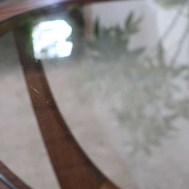 Mid-century vintage British teak G-PLAN coffee table with curved wood frame and oval glass top showing rich wood grain.