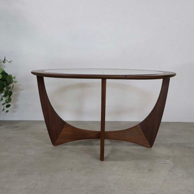 Vintage British G-Plan mid-century teak coffee table with rounded glass top and sculpted curved legs.