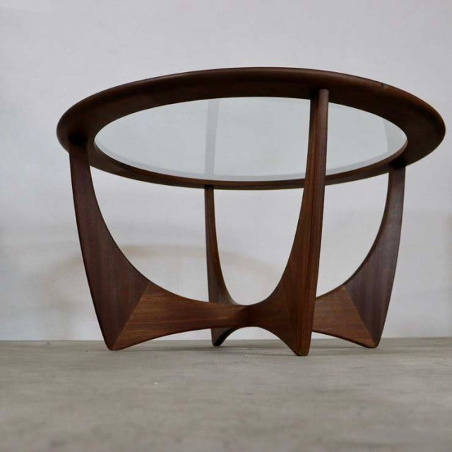 Vintage British mid-century G-PLAN teak coffee table with round glass top and sculptural tripod base.