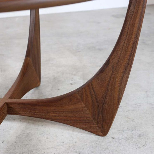 Close-up of vintage teak wood leg from British mid-century G-PLAN coffee table, showcasing smooth grain and sculpted form.