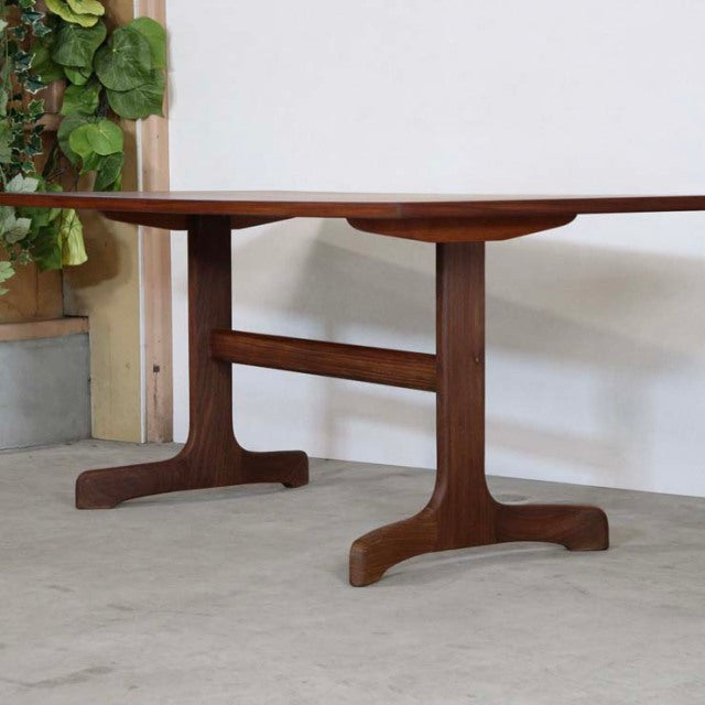 Mid-century British G-PLAN dining table in vintage teak with rich wood grain, T-shaped legs, and solid rectangular top.