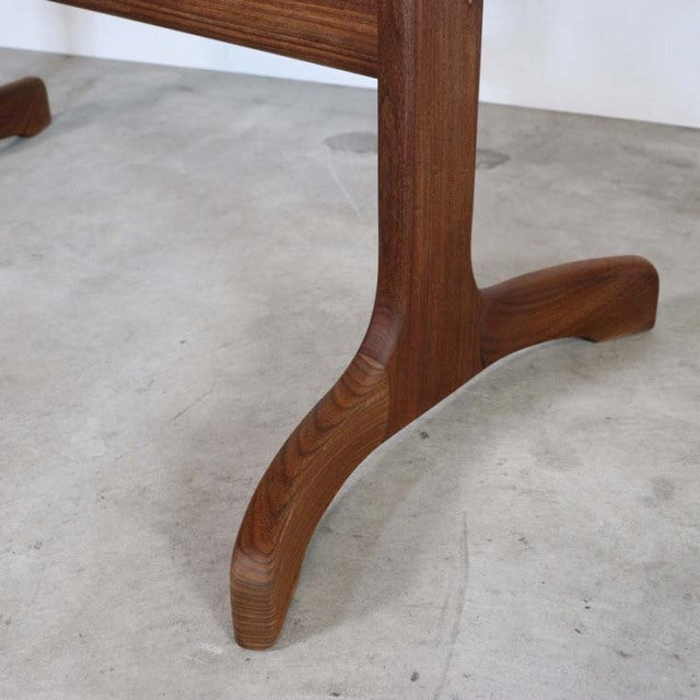 Close-up of vintage teak dining table leg by British mid-century G-PLAN, smooth wood grain, curved base design from Denmark.