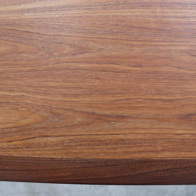 Close-up of vintage British G-Plan mid-century teak dining table top showing rich wood grain and smooth finish.
