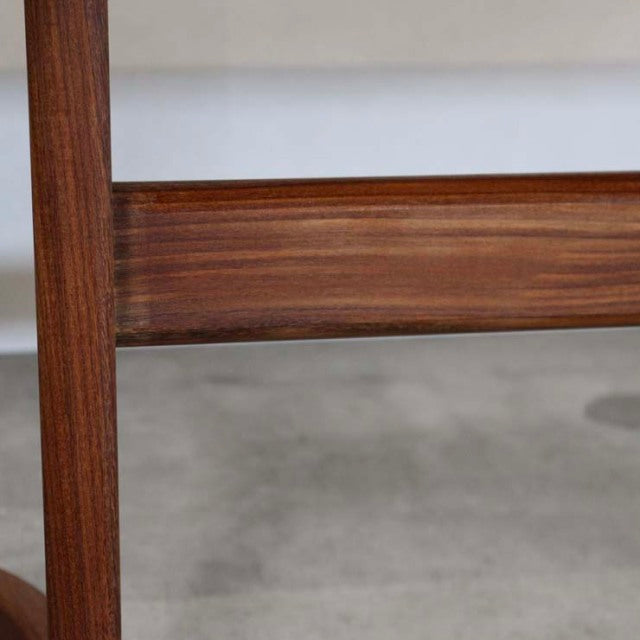 Close-up of vintage British G-Plan teak dining table leg and stretcher showcasing mid-century wood grain and craftsmanship.
