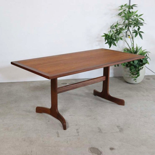 Mid-century British G-Plan vintage teak dining table with rectangular top and curved pedestal legs.