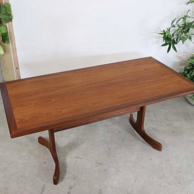 Vintage British G-Plan teak dining table with rich wood grain, mid-century design, and elegant curved legs.