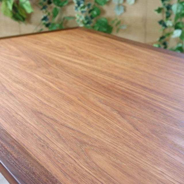 Vintage British mid-century teak dining table by G-Plan with rich wood grain and tapered legs.