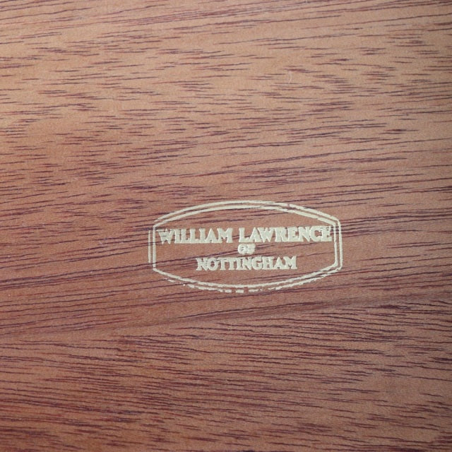 William Laurence Nottingham brass inlay logo on rich teak wood grain, vintage British mid-century craftsmanship from Denmark.