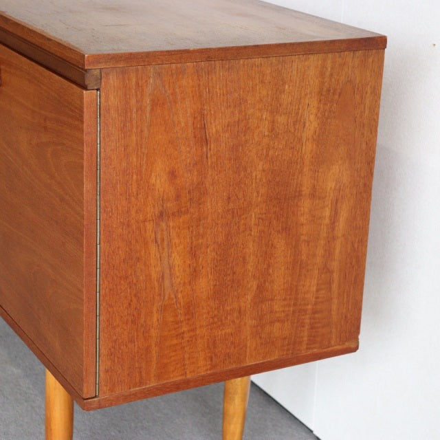 Vintage teak mid-century British William Laurence sideboard showing rich wood grain and clean-lined rectangular form with.
