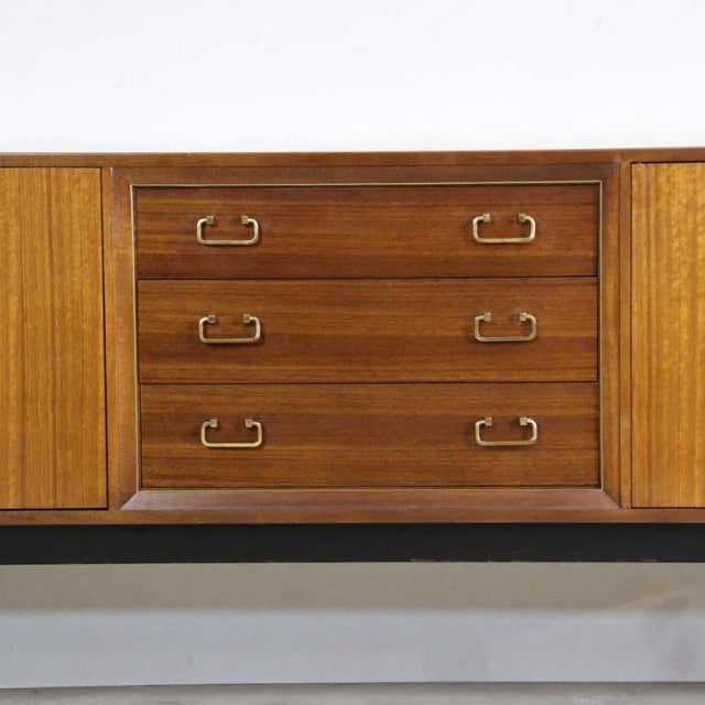Vintage mid-century teak G-Plan sideboard with clean lines, brass handles, and wood grain detail, British-Denmark design.