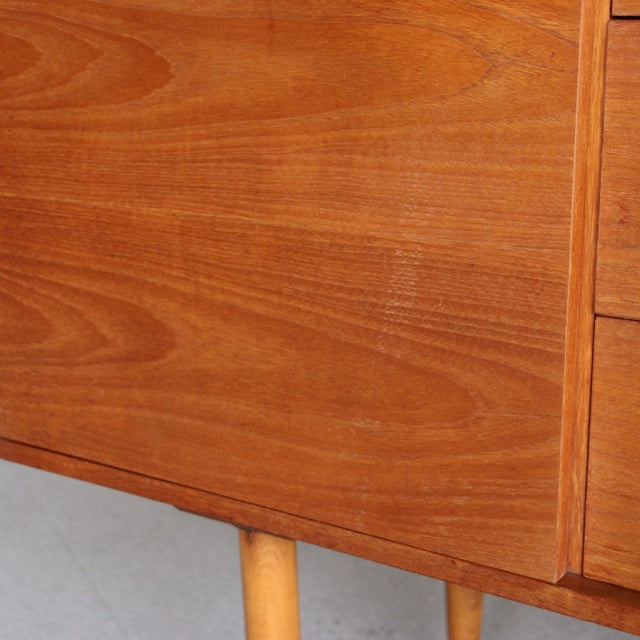 Mid-century British vintage teak sideboard by William Laurence with smooth wood grain and tapered legs.