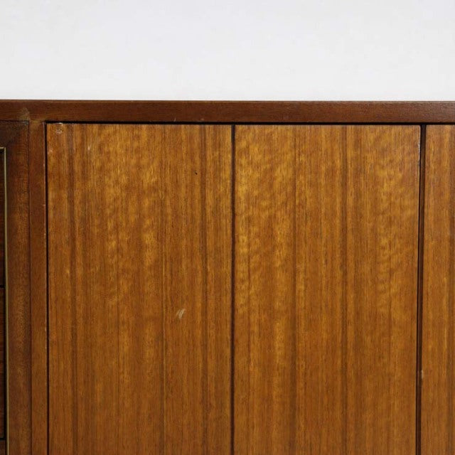 Vintage mid-century British G-PLAN teak sideboard with warm wood grain and clean vertical panel doors.