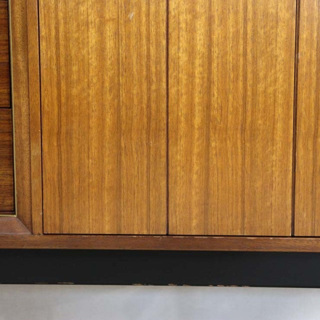 Mid-century British G-PLAN Goldstamp teak sideboard with vertical wood grain and tapered legs.