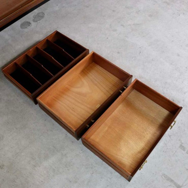 Three open teak drawers from a vintage British mid-century G-PLAN sideboard, showing wood grain and compartment dividers.