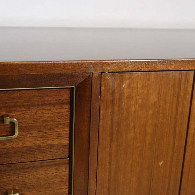 Close-up of vintage British G-PLAN mid-century teak sideboard showing warm wood grain and brass handle details.