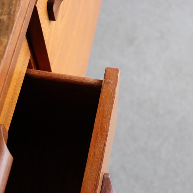 Mid-century vintage British teak sideboard drawer with visible wood grain and sleek handle design, Scandinavian influence.