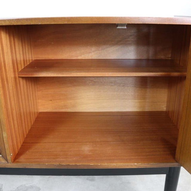 Open view of vintage teak G-PLAN Goldstamped mid-century British sideboard interior with visible wood grain and shelf.