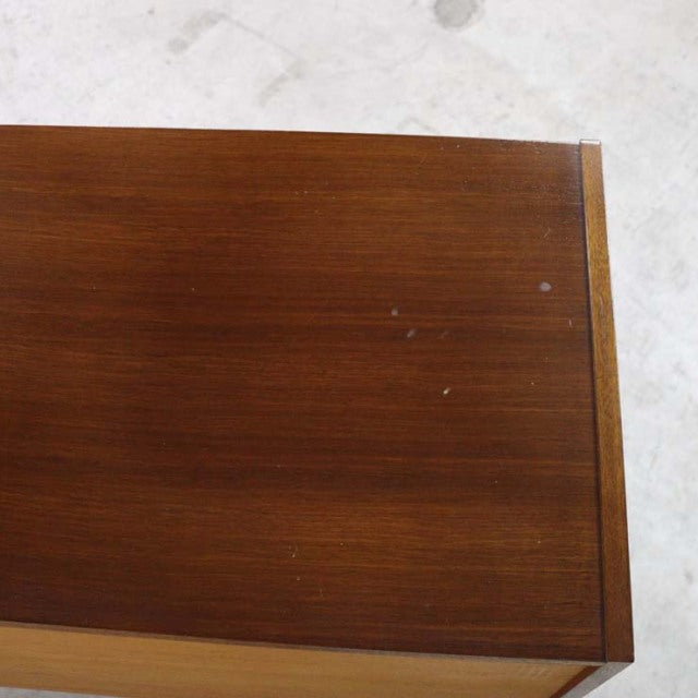 Close-up of vintage teak wood top with warm grain and small surface marks on British mid-century G-Plan sideboard.