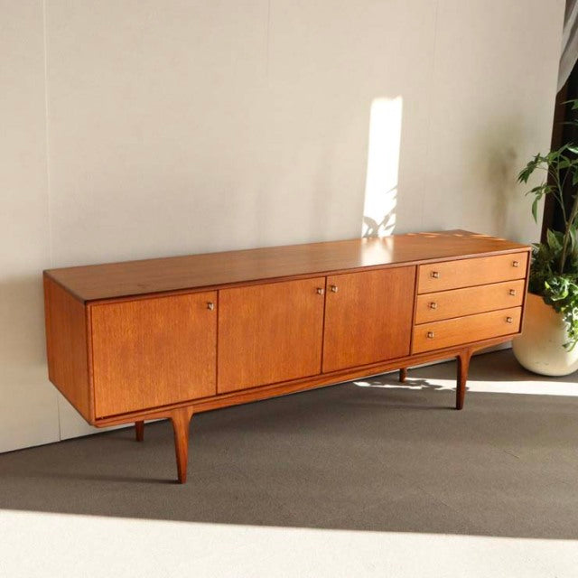 Vintage teak sideboard by YOUNGER with sleek British mid-century design, smooth wood grain, tapered legs, and clean.