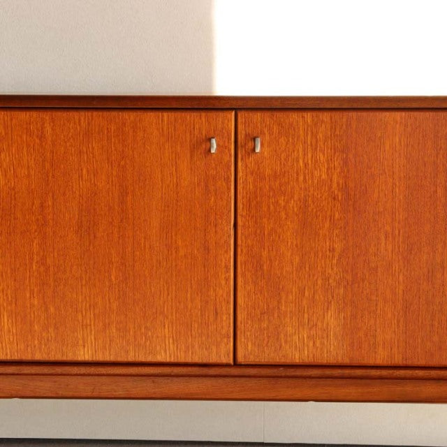 Vintage teak sideboard by Younger, British mid-century design with warm wood grain and sleek handles.