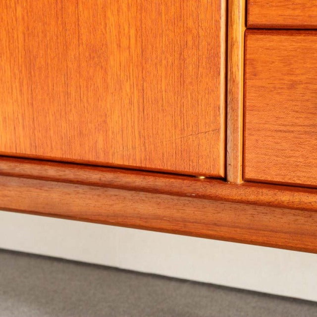 Close-up of vintage teak sideboard by Younger showcasing warm wood grain and mid-century British craftsmanship with smooth.