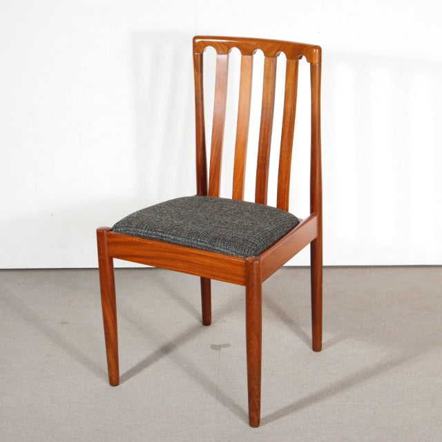 Mid-century British vintage teak dining chair by MEREDEW with slatted back and dark gray upholstered seat.