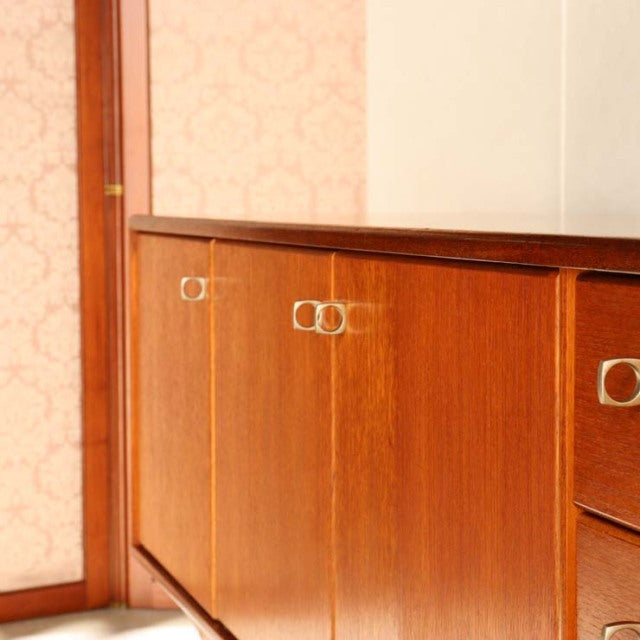 Vintage teak sideboard by Younger featuring British mid-century design, smooth wood grain, and sleek metal handles.