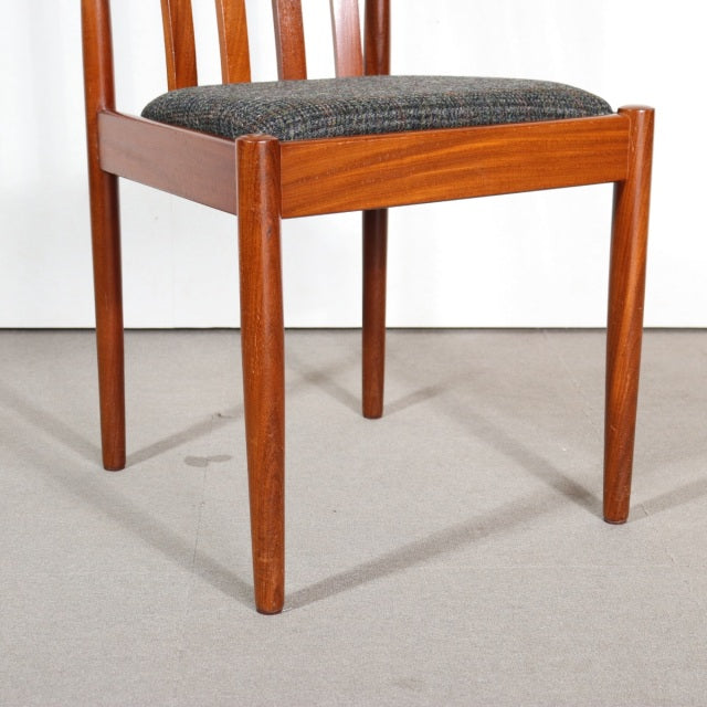 Vintage teak dining chair by MEREDEW with British mid-century design, tapered legs, and dark upholstered seat.