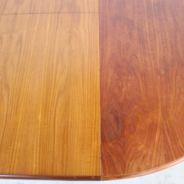 Close-up of vintage British mid-century teak dining table showcasing warm wood grain and rounded edge, Elliott of Newbury.