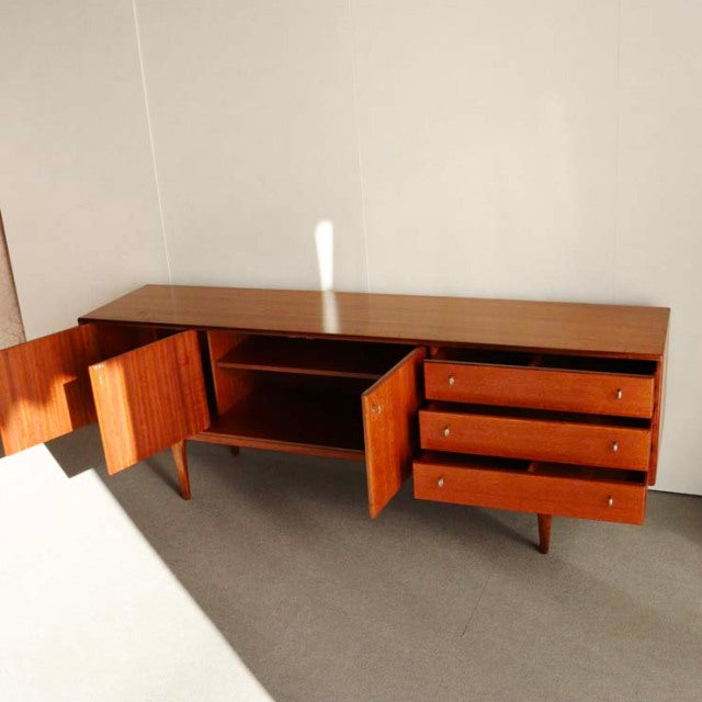 Vintage teak sideboard by Younger featuring a mid-century British-Denmark design, with tapered legs, three drawers, and two.