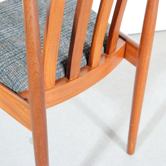 Mid-century British vintage teak dining chair with natural wood grain, tapered legs, and blue-gray upholstered seat from.